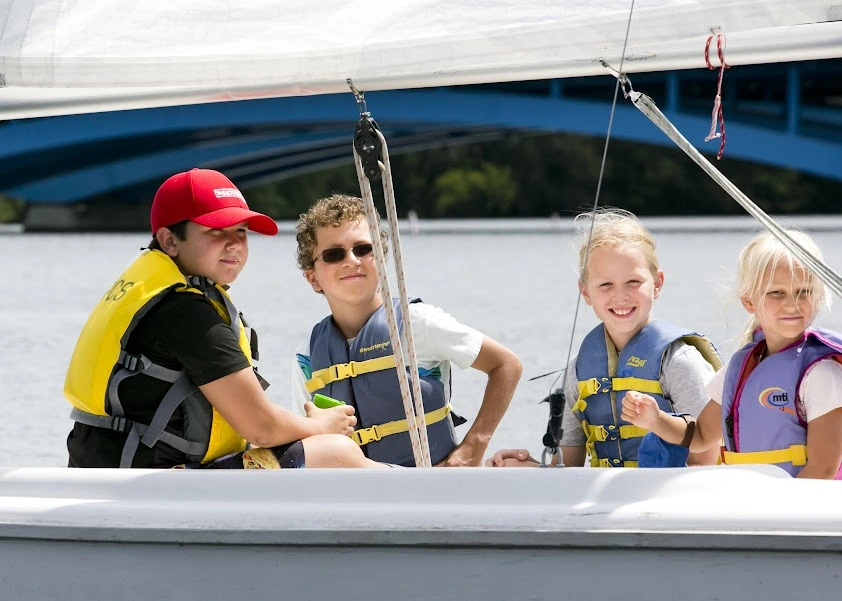 four kids on a sailboat