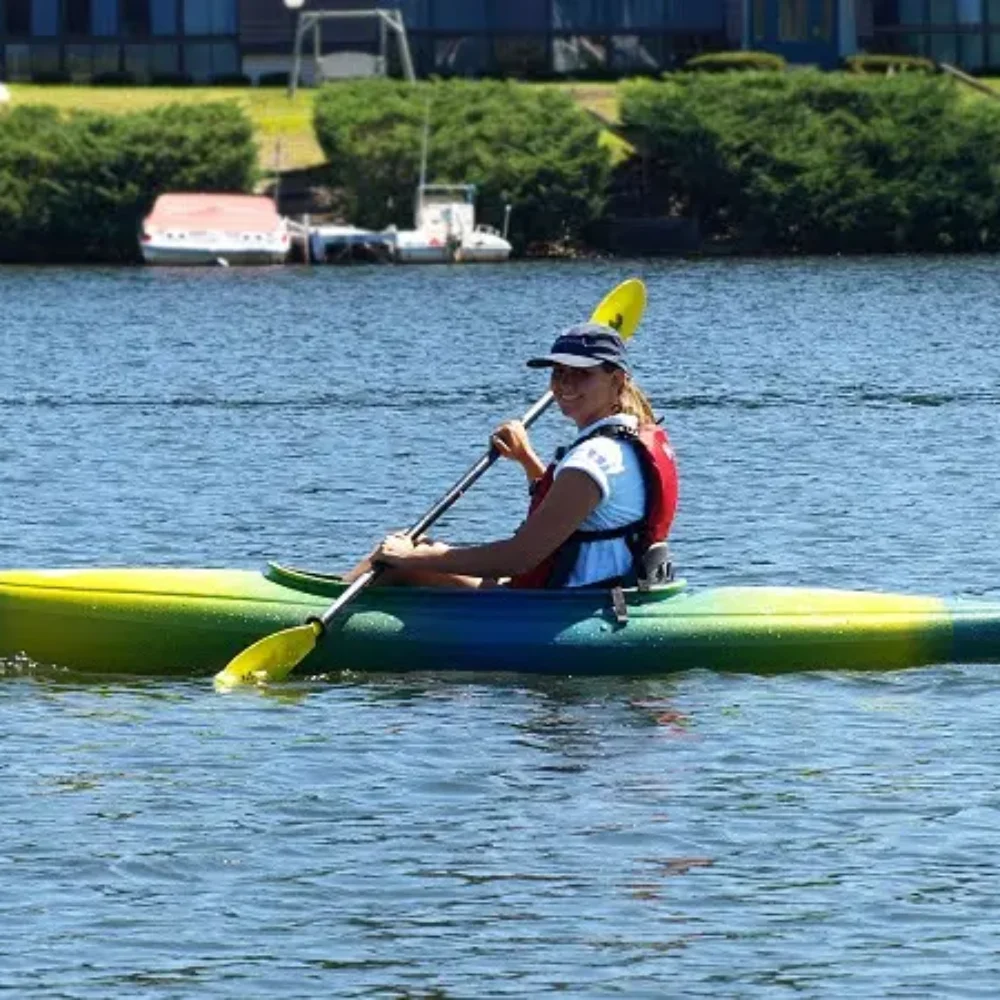 Woman paddling in rented single kayak