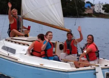 five adults on a sailboat