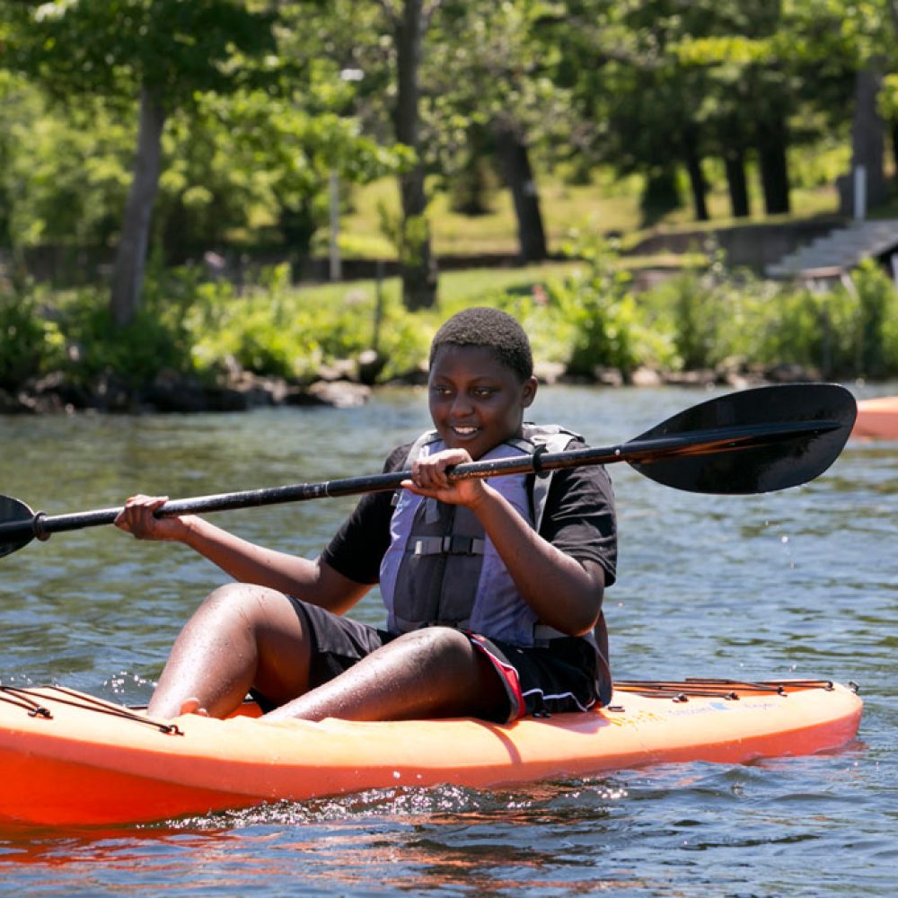 teenager-rowing-a-kayak